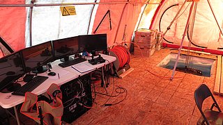 Heated tent with a hole in the ice for deploying the ROV.