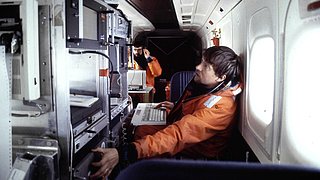 Scientists on board the Polar 4 during a survey flight over the Arctic sea ice.
