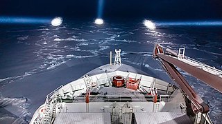 Polarstern navigates through the ice by night.